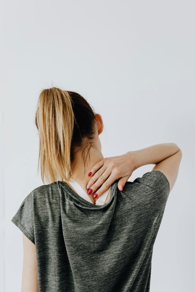 A woman rubbing the back of her neck and feeling better